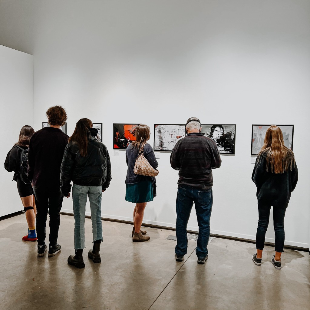 People looking at art in a gallery.