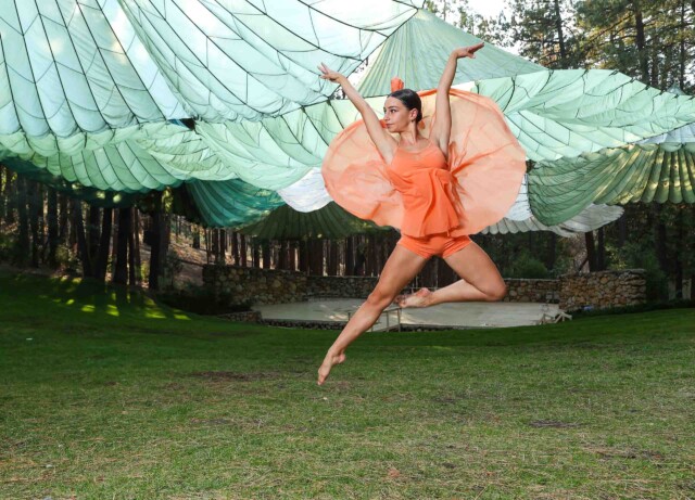 A dance student dancing outside.