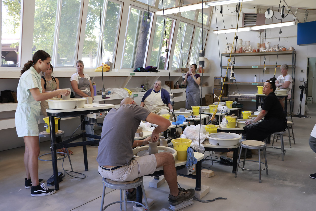 Students working on hot clay.